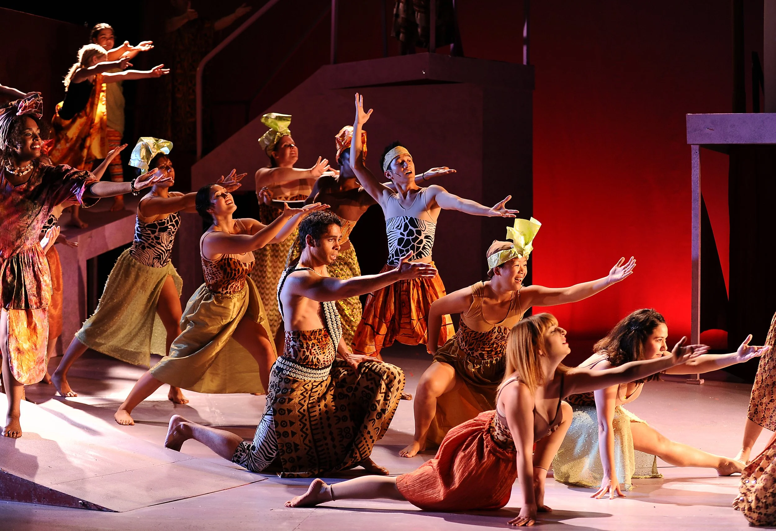 Ensemble performing A Little Princess under warm stage light.
