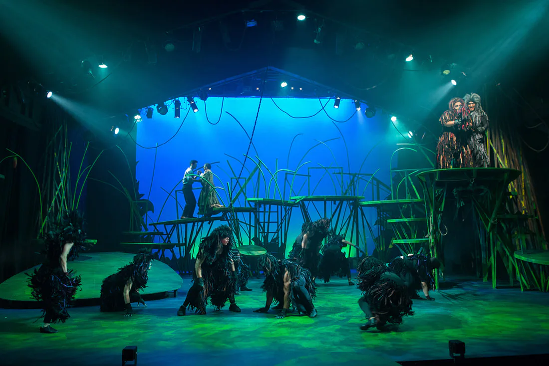 The ape ensemble moving across the full jungle stage.