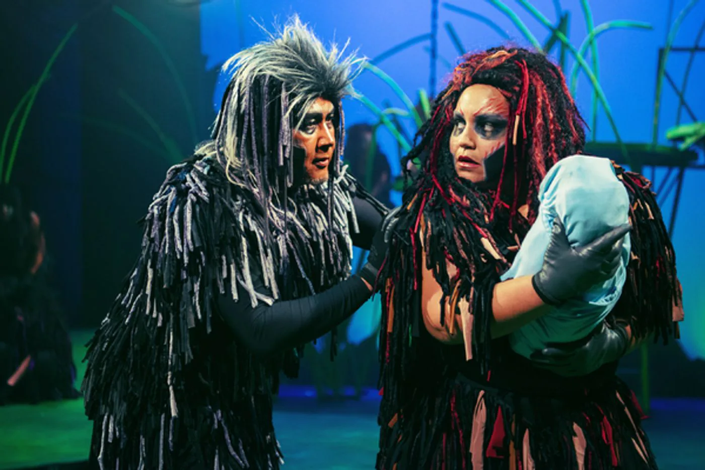 Kerchak and Kala holding the infant Tarzan.